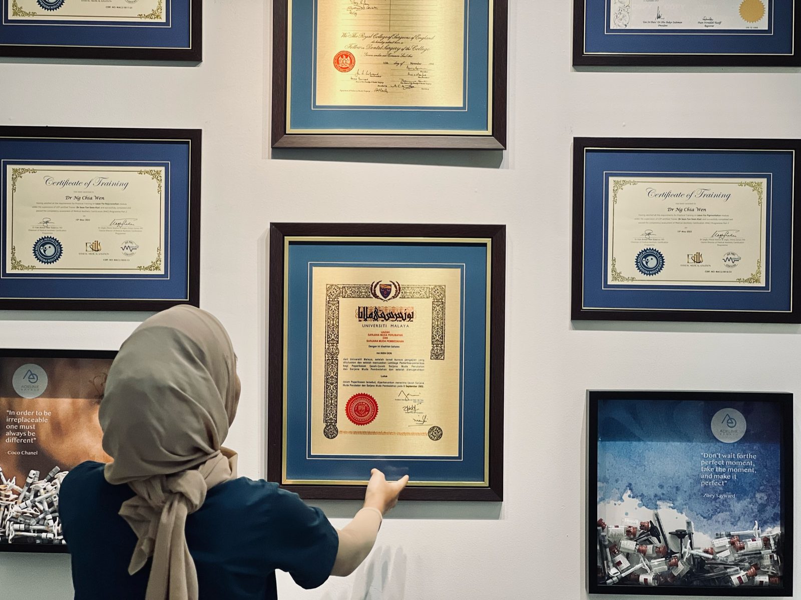 Framed medical qualifications and training certificates at AOKLINIK Penang